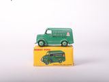a green toy truck sitting on top of a yellow box