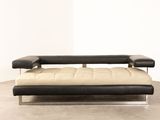 an image of a black and white couch in a white room