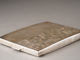a small silver cigarette case sitting on a table