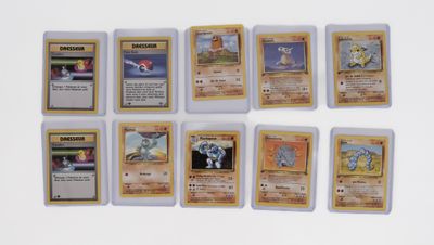several pokemon cards are lined up on a white surface