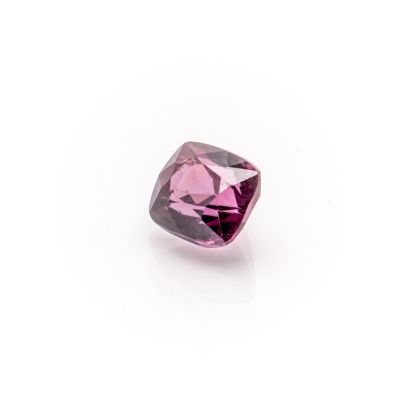 a pink diamond on a white surface with a white background