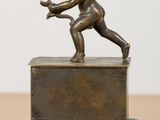 bronze statue of a cupid with a bow and arrow on a pedestal