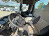 a view of the inside of a truck from the driver ' s seat