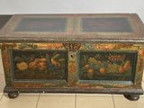a wooden chest with a painting on it