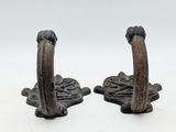 pair of antique cast iron bookends on white background