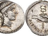 a silver coin with a woman ' s head and hands on it