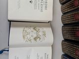 several books are stacked on top of each other on a table