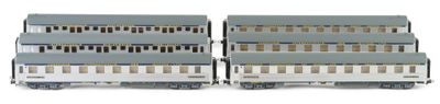 two gray and white train cars sitting side by side on a white surface