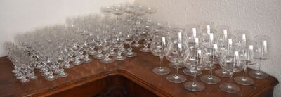 a lot of wine glasses sitting on a wooden table