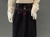 an image of a mannequin wearing a white blouse and black skirt