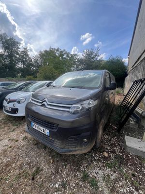 a car that is parked in a lot next to a building