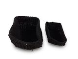 pair of black knitted baskets on a white surface with a white background