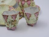 three cups and a saucer sitting on a table