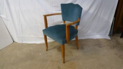 a blue chair that is sitting in front of a white backdrop