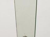 mirror on a wooden table with a metal base and a curved glass top