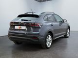 the rear end of a grey volkswagen suv parked in a room