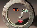 a sculpture of a face in a circle on a table