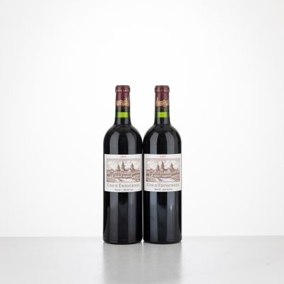 two bottles of wine sitting on top of a table next to each other