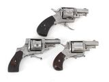 two revolvers are shown on a white surface with a white background