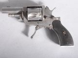 a gun that is sitting on a white surface