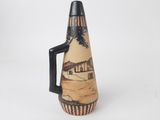 a vase that has a picture of a house on it