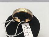 une bague munie d'une étiquette, posée dans une boîte noire