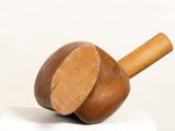 a wooden object that is on top of a white box