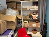 a room filled with boxes and a chair in it