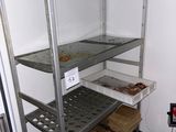 a metal shelf with food on it in a kitchen