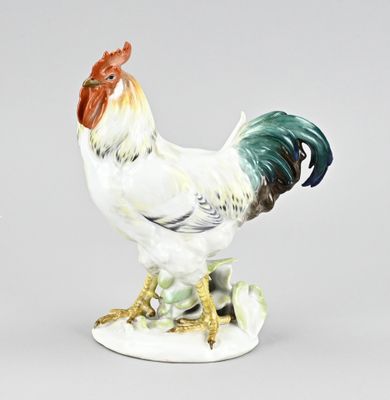 a figurine of a rooster on a white base