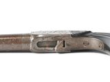 an old gun that is sitting on top of a white surface