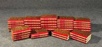many books stacked on top of each other on a table