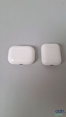two white apple airpods sitting next to each other on top of a table