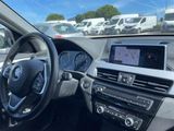 a picture of a car dashboard with a view of a parking lot in the background