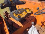 a tractor that is sitting in a field with a bag