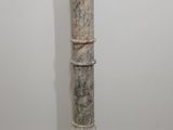 marble pedestal in the shape of a column in a white room