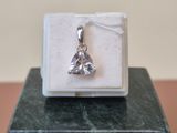 sterling silver plated charm with a heart on it on a marble block