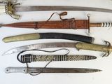 many different types of knives on display on a table