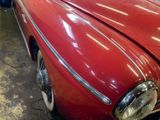 a red car that is parked in a garage