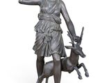 bronze statue of a woman with a deer and a knife