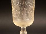 a glass cup that is sitting on a table