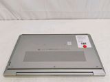 a silver laptop with a red button on it