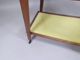 a wooden table with a yellow tray on it