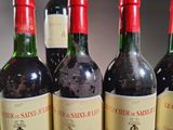 several bottles of wine are lined up in a row on a table