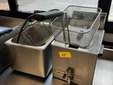 two deep fryers sitting on the counter in the kitchen