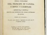 an open book on a white surface with a black border