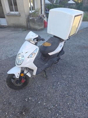 a scooter with a box on the back of it