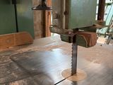 a machine that is cutting a piece of wood on a table