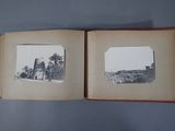 an old photo of a book opened to show a picture of a beach and palm trees