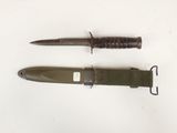 two knives are laying next to each other on a white surface